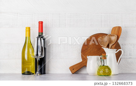 Kitchen utensils and wine bottles on table Kitchen utensils and wine bottles on table 132668373