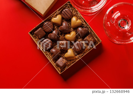 A glasses of champagne elegantly paired with a box of rich chocolates A glasses of champagne elegantly paired with a box of rich chocolates 132668946