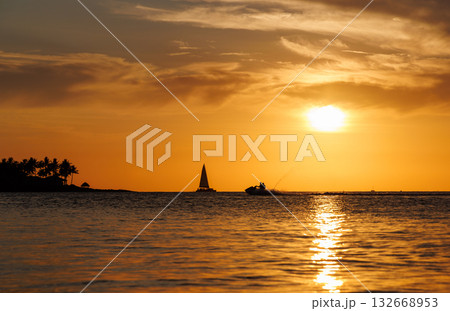 Sunset over the sea with sailing boats on the horizon Sunset over the sea with sailing boats on the horizon 132668953