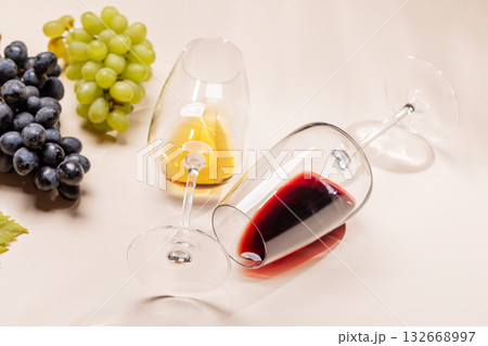 Wine glasses and grapes on beige background 132668997
