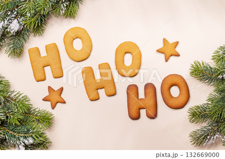 Ginger cookies shaped as Ho Ho Ho with fir branches , Christmas card style Ginger cookies shaped as Ho Ho Ho with fir branches , Christmas card style 132669000