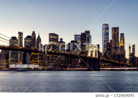 A panoramic sunset view of the Brooklyn Bridge stretching towards Manhattan A panoramic sunset view of the Brooklyn Bridge stretching towards Manhattan 132669095