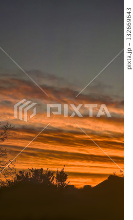 The red-crimson and orange evening sky over the city. Fiery sunset. The red-crimson and orange evening sky over the city. Fiery sunset. 132669643