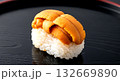Japanese minimalist. a single, glistening piece of uni (sea urchin) gunkan-maki, showcasing its complex orange texture, creamy structure, on a smooth, black lacquer tray Japanese minimalist. a single, glistening piece of uni (sea urchin) gunkan-maki, showcasing its complex orange texture, creamy structure, on a smooth, black lacquer tray 132669890
