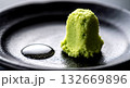 Wabi-sabi aesthetic, a small mound of freshly grated wasabi root, its vibrant green fibers, texture in sharp, next to a drop of condensation on a dark ceramic dish Wabi-sabi aesthetic, a small mound of freshly grated wasabi root, its vibrant green fibers, texture in sharp, next to a drop of condensation on a dark ceramic dish 132669896