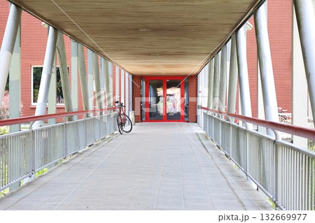 Modern Covered Walkway with Red Double Doors and Bicycle 132669977