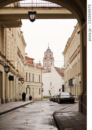 Historic Church Bell Tower Framed by Stone Archway in Old Town 132669978
