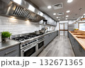 Professional commercial kitchen with stainless steel equipment and wood counters 132671365