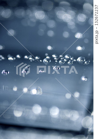 Close up of abstract floating bubbles water droplets condensation rain on a glass transparent bokeh background 132672237