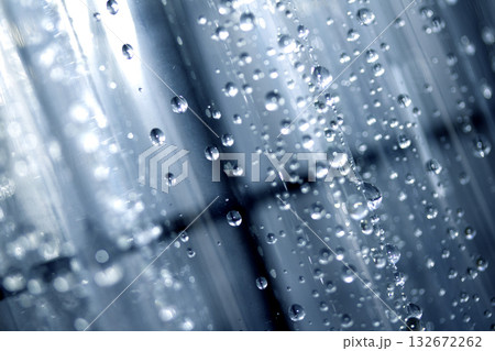 Close up of abstract floating bubbles water droplets condensation rain on a glass transparent bokeh background 132672262