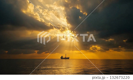A Dramatic Sunset Over An Offshore Oil Rig Enveloped by the Serene and Tranquil Vast Ocean Waters Nearby 132673220