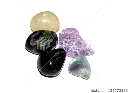 Close up of a healing crystal quartz rock stone on white background Close up of a healing crystal quartz rock stone on white background 132673326