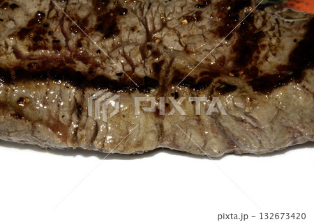 Close up of a cooked grilled steak slice on white background 132673420