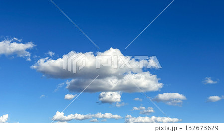 Puffy Clouds Floating in a Clear Blue Sky on a Sunny Day Puffy Clouds Floating in a Clear Blue Sky on a Sunny Day 132673629