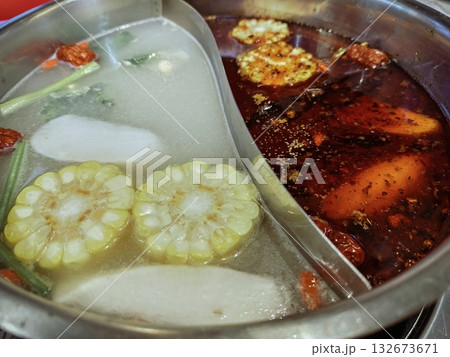 Chinese Hot Pot with Spicy Mala and Clear Soup Base, with Corn and Vegetables 132673671