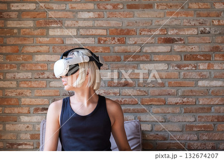 Teenager wearing virtual reality headset. Immersive gaming experience and educational technology. Teenager wearing virtual reality headset. Immersive gaming experience and educational technology. 132674207