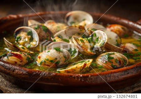 Steaming clams with garlic and parsley in traditional clay pot 132674801