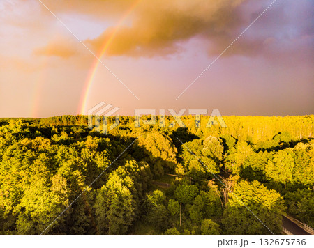 Rainbow over forest area, Poland. Aerial view 132675736