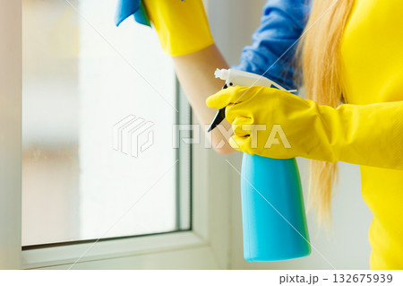 Hand cleaning window at home using detergent rag Hand cleaning window at home using detergent rag 132675939