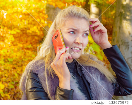 Fashion female talking on mobile phone outdoor 132675975