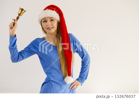 Christmas woman holding bell. 132676037