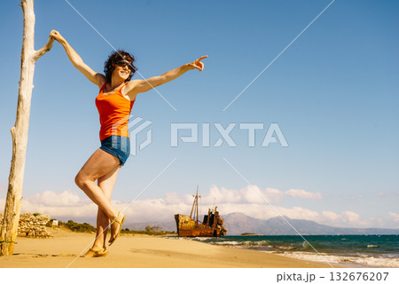 Tourist woman on beach enjoying vacation Tourist woman on beach enjoying vacation 132676207