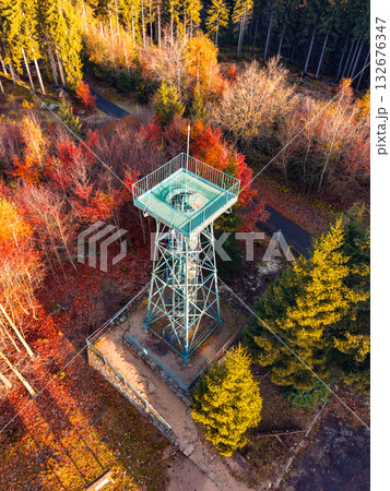 Slovanka Lookout Tower, the oldest iron tower in the Czech Republic, stands tall amidst vibrant autumn foliage in the Jizera Mountains, inviting visitors to enjoy stunning views. Slovanka Lookout Tower, the oldest iron tower in the Czech Republic, stands tall amidst vibrant autumn foliage in the Jizera Mountains, inviting visitors to enjoy stunning views. 132676347