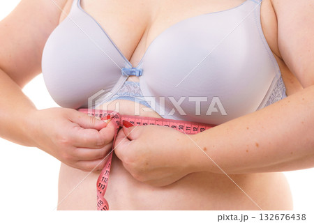 Woman plus size measuring her chest under breast Woman plus size measuring her chest under breast 132676438