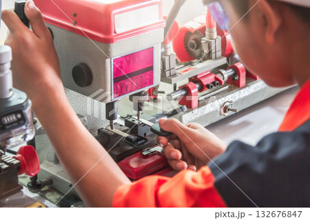 Locksmith in workshop makes new key. Professional making key in locksmith. Locksmith in workshop makes new key. Professional making key in locksmith. 132676847