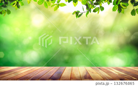 Empty brown wooden table with Fresh and green leaves green bokeh on nature abstract blur background green bokeh from tree. Empty brown wooden table with Fresh and green leaves green bokeh on nature abstract blur background green bokeh from tree. 132676865