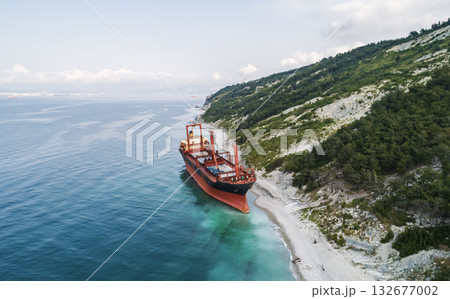 Aerial view of an abandoned bulk-carrier dry cargo ship washed ashore after a storm 132677002