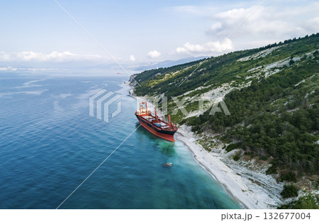 Aerial view of an abandoned bulk-carrier dry cargo ship washed ashore after a storm Aerial view of an abandoned bulk-carrier dry cargo ship washed ashore after a storm 132677004