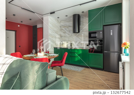 Modern Kitchen and Living Area with Green Cabinets and Red Chairs Modern Kitchen and Living Area with Green Cabinets and Red Chairs 132677542