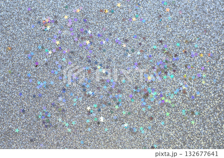 Sparkling glitter background with colorful star confetti and festive shimmer texture 132677641
