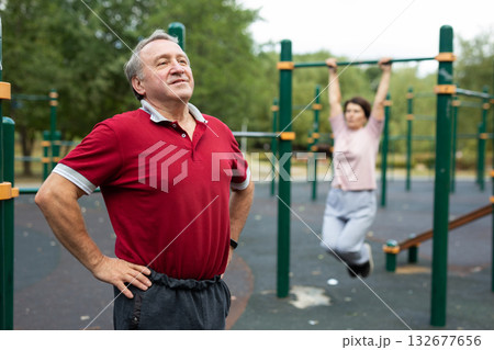 Stretching and active senior man at park for training, exercise and cardio wellness. Fitness, arm stretch 132677656