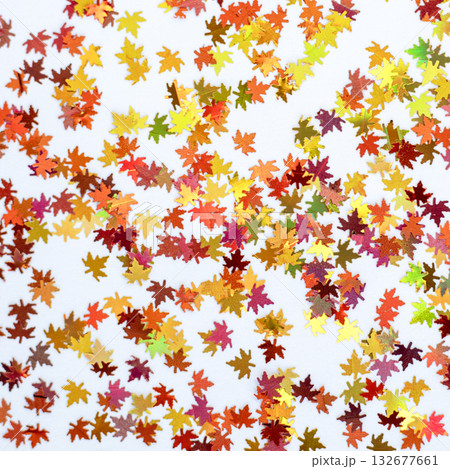 Colorful maple leaf confetti scattered on white background for festive celebration and decor event photos Colorful maple leaf confetti scattered on white background for festive celebration and decor event photos 132677661