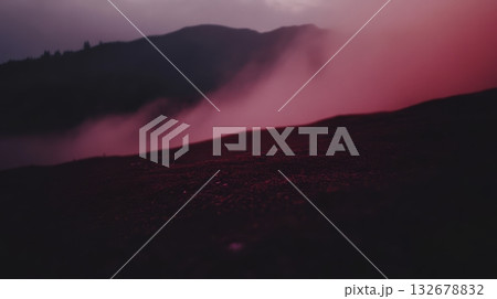 Misty landscape at dusk with pink and purple hues 132678832
