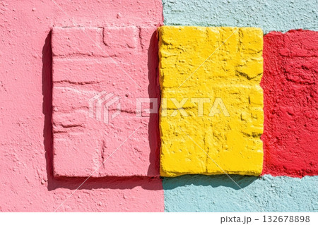Colorful textured wall with yellow, pink, and red blocks 132678898