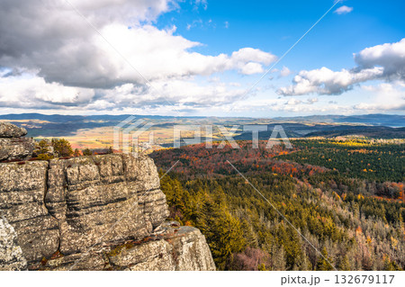 Journey to the Southern Terraces in Stolowe Mountains National Park, Poland, to enjoy stunning panoramic views surrounded by vibrant autumn colors and unique sandstone formations. 132679117