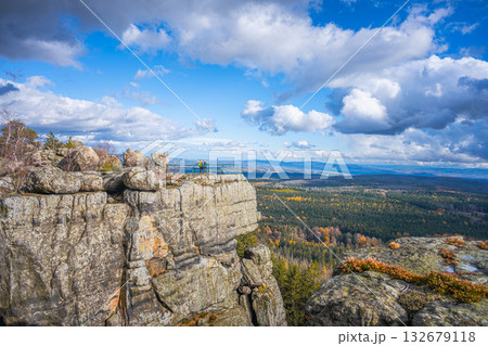Visitors enjoy breathtaking views from lookout points in Southern Terraces, Stolowe Mountains National Park during autumn. The vibrant fall colors contrast with rugged sandstone formations. Visitors enjoy breathtaking views from lookout points in Southern Terraces, Stolowe Mountains National Park during autumn. The vibrant fall colors contrast with rugged sandstone formations. 132679118