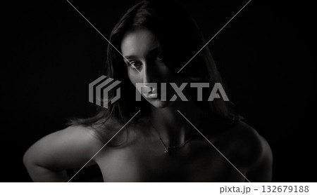 Fashion model posing in low key lighting for beauty portrait Fashion model posing in low key lighting for beauty portrait 132679188