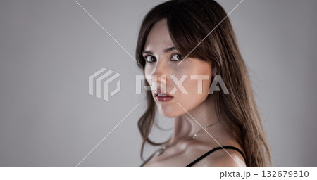 Fashion model posing and looking over her shoulder 132679310