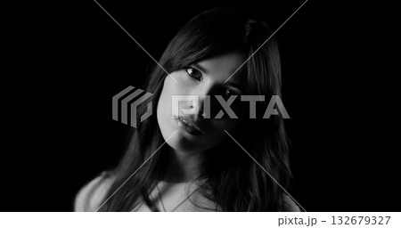 Fashion model posing in black and white with a black background 132679327