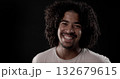 Young african-american man with curly hair smiling on black background 132679615