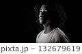Young african-american man with curly hair looking up in black and white 132679619