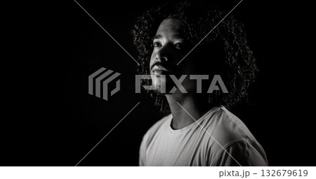 Young african-american man with curly hair looking up in black and white Young african-american man with curly hair looking up in black and white 132679619