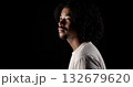 Young african-american man with curly hair looking up on black background 132679620