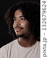 Young african-american man with curly hair looking up and smiling 132679624