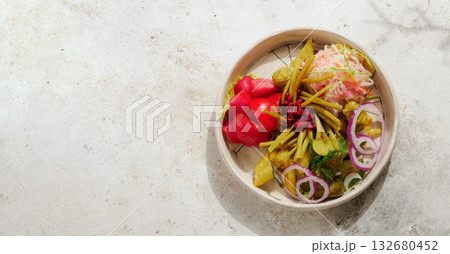 Assorted snacks from fermented cabbage, cucumbers and tomatoes, green bean. Decorated cranberry. Fermented healthy food concept. Pickled cucumbers, marinated tomatoes. Top view or flat lay. Assorted snacks from fermented cabbage, cucumbers and tomatoes, green bean. Decorated cranberry. Fermented healthy food concept. Pickled cucumbers, marinated tomatoes. Top view or flat lay. 132680452