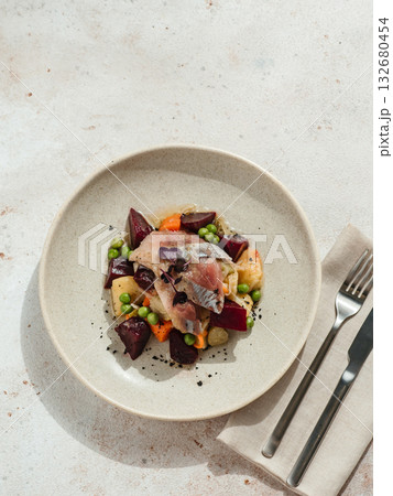 Restaurant dish with fish snack. Salted herring, potatoes, beets, carrots, green peas decorated microgreens. Pickled Herring Fish. Top view or flat lay 132680454